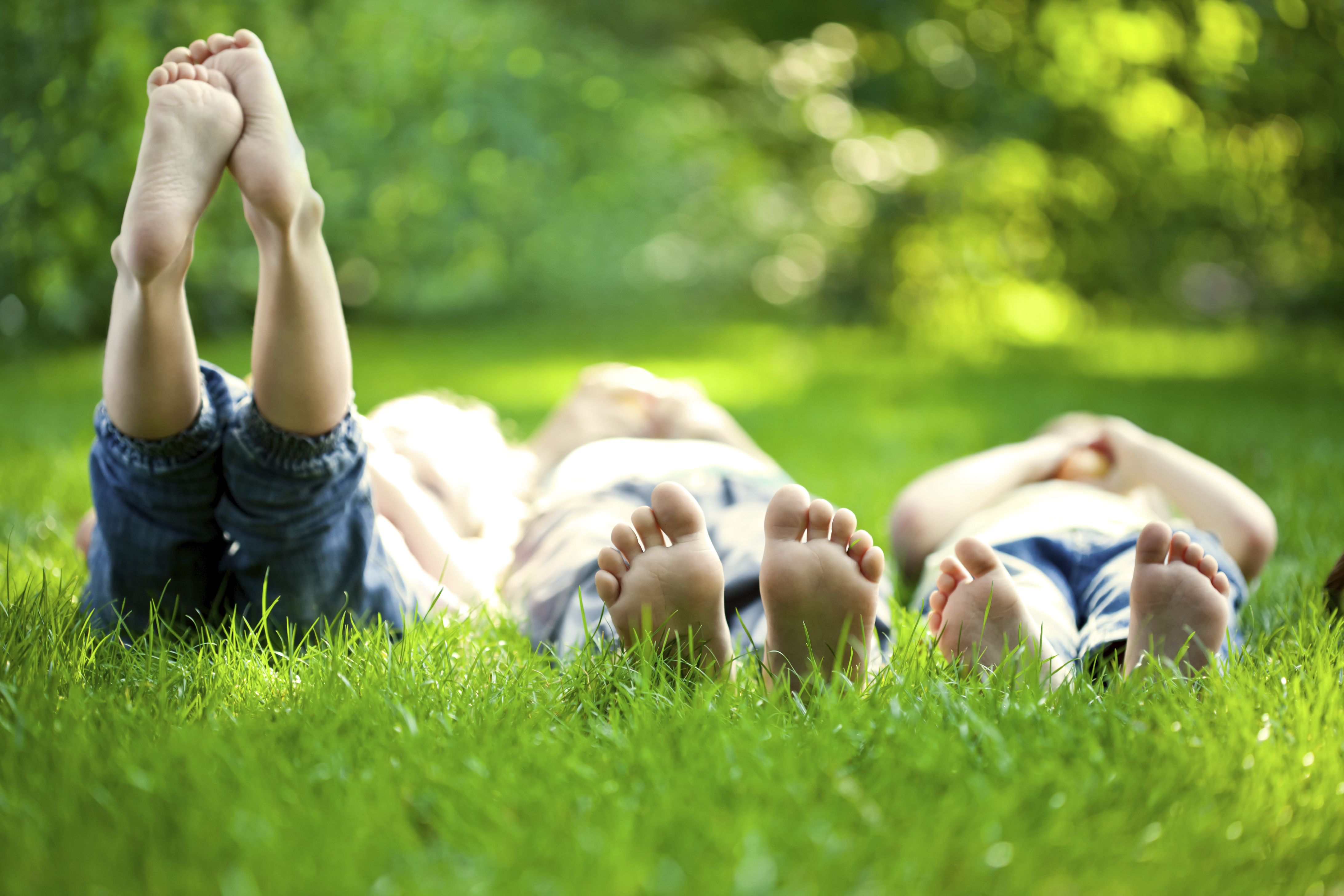 Image of children with bare feet in the grass. 