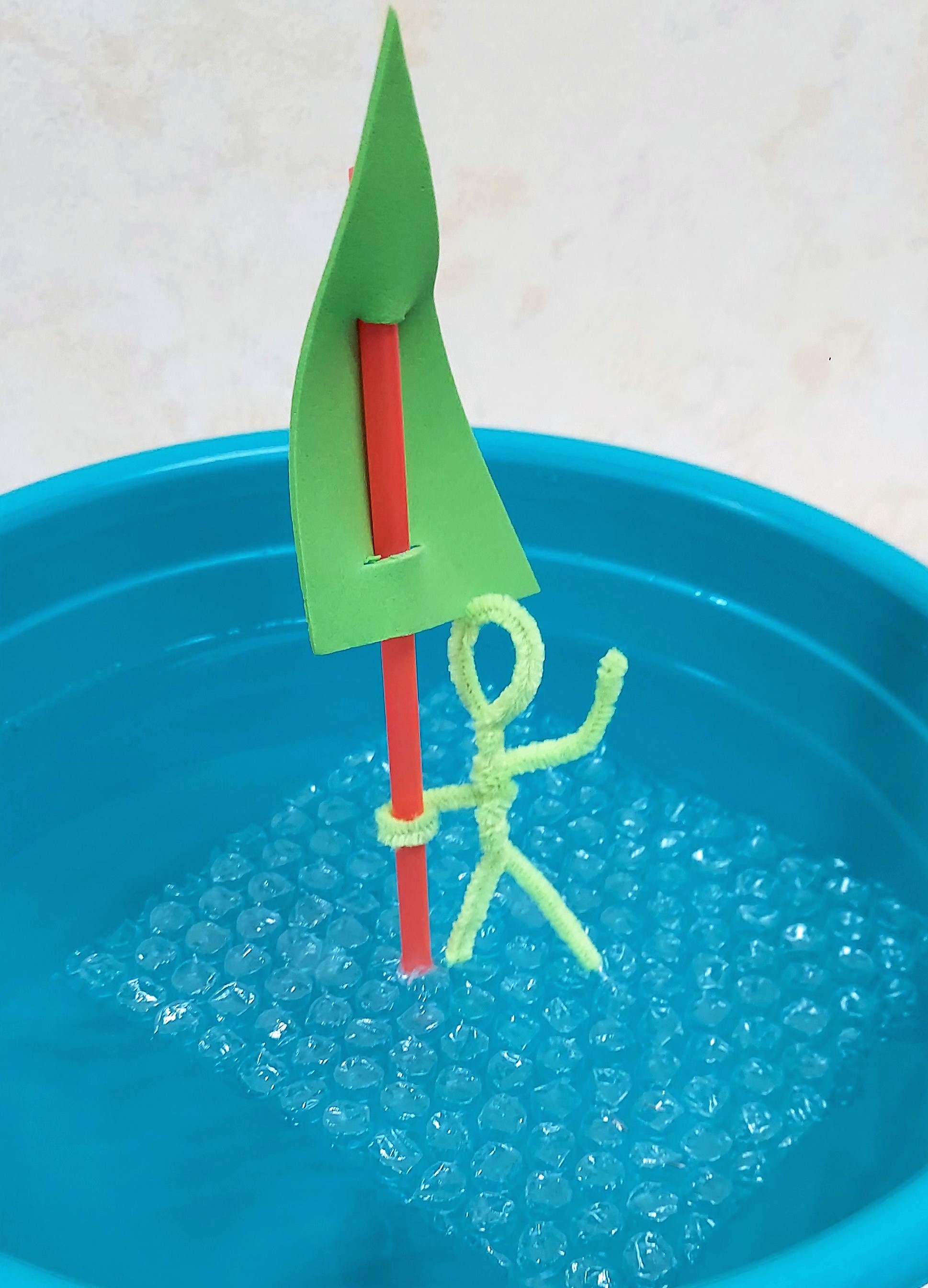 Image of green stick figure floating on bubble wrap raft.