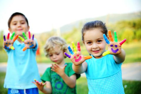 Image of kids with painted hands. 