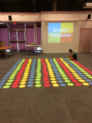 Image of a giant Twister game board on the floor
