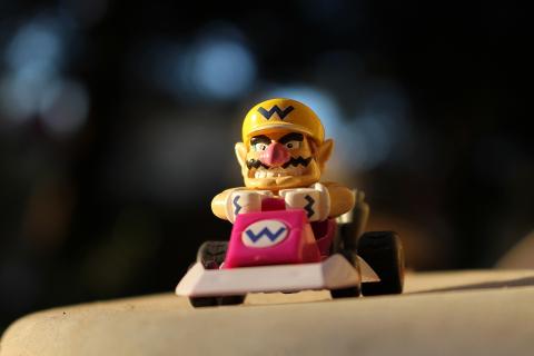An image of Wario in a kart. 