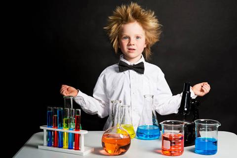 Image of a boy scientist with wild hair and many beakers of colorful liquids