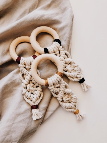 White macrame pattern on wooden circle