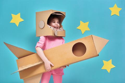 Girl with cardboard rocket
