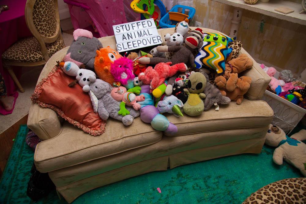 Image of stuffed animals arranged on a couch.