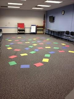 Image of Chutes and Ladders game on carpet.