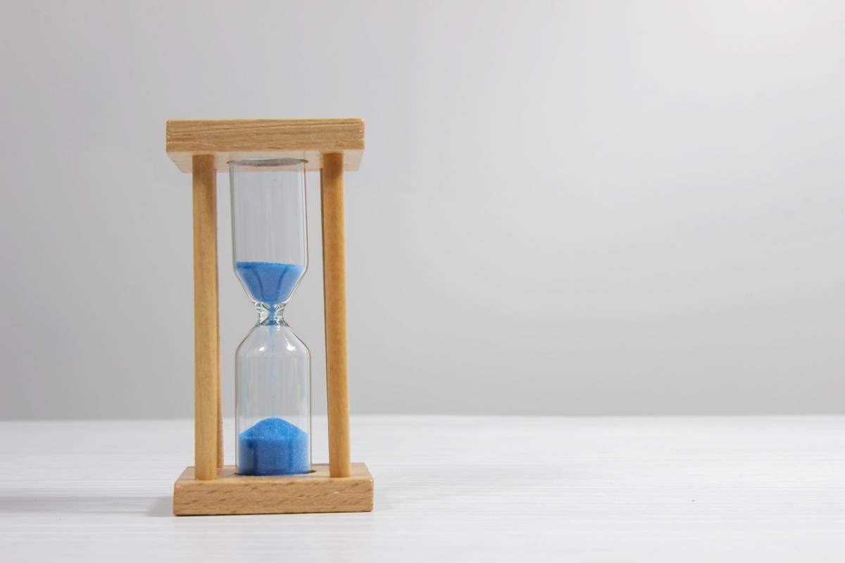 An image of colored sand in an hourglass