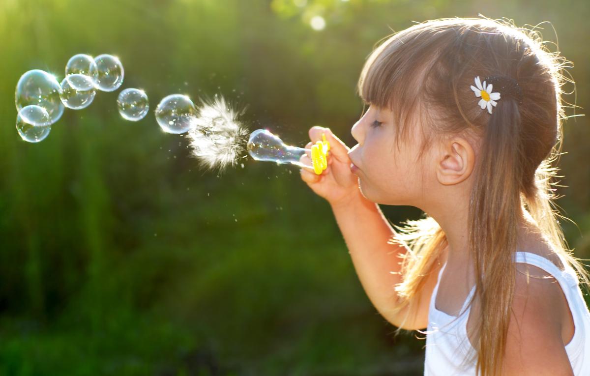 Girl blowing bubbles. 